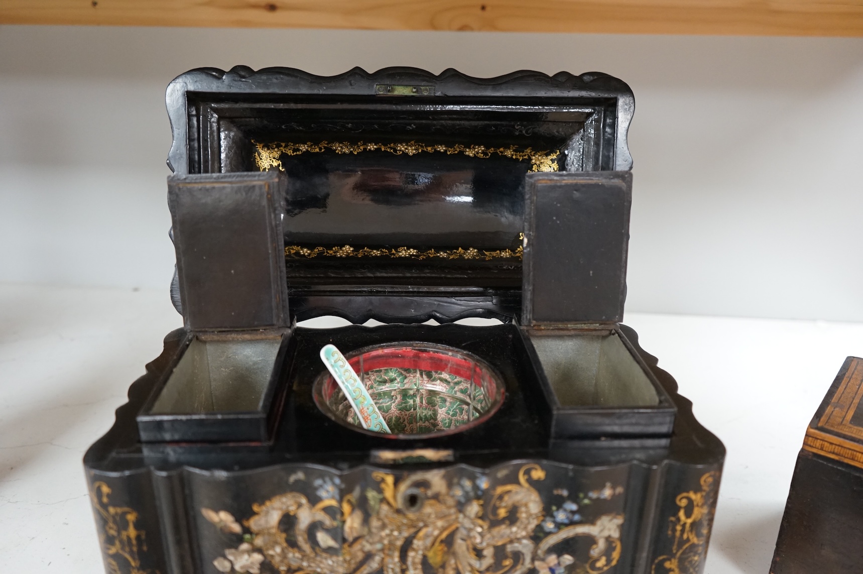 A large Victorian Papier maché and mother-of-pearl tea caddy, 32cm wide, and a Sorrento ware marquetry tea caddy, 19.5cm wide.